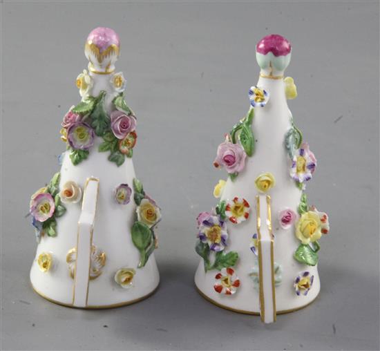 A pair of Meissen floral encrusted candle extinguishers, 19th century,